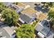 Aerial view of a home featuring a grey roof, a two-car garage, and mature trees at 1415 Hensley Dr, Deland, FL 32724