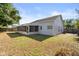 Spacious backyard featuring a screened lanai and well-kept lawn at 1415 Hensley Dr, Deland, FL 32724