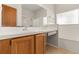 Bathroom features single vanity, tub, and large mirror at 1415 Hensley Dr, Deland, FL 32724