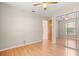 Bedroom with hardwood floors, a ceiling fan, and a mirrored closet at 1415 Hensley Dr, Deland, FL 32724