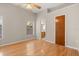 Bright bedroom features hardwood floors, ceiling fan, and window for natural light at 1415 Hensley Dr, Deland, FL 32724