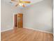 Neutral bedroom showcases beautiful hardwood floors and a ceiling fan at 1415 Hensley Dr, Deland, FL 32724
