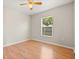 Bedroom with hardwood floors, ceiling fan and one window with blinds at 1415 Hensley Dr, Deland, FL 32724
