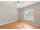 Bedroom with hardwood floors, a ceiling fan and one large window with blinds at 1415 Hensley Dr, Deland, FL 32724