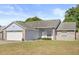 Welcoming single-story home featuring a brick and siding exterior with a two-car garage at 1415 Hensley Dr, Deland, FL 32724