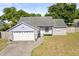 Charming single-story home with a well-maintained lawn and a two-car garage at 1415 Hensley Dr, Deland, FL 32724