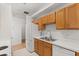 Functional kitchen includes white appliances and wood cabinetry at 1415 Hensley Dr, Deland, FL 32724