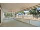 Spacious screened-in porch with ceiling fan and view of the fenced backyard at 1415 Hensley Dr, Deland, FL 32724