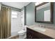 Nicely appointed bathroom with tub shower combo, wood cabinets and granite countertop at 145 Henue Ct, Davenport, FL 33896