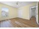 Bedroom with wood-look flooring, a double door closet, and a bright window at 145 Henue Ct, Davenport, FL 33896
