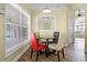Charming dining area with wood floor, pendant lighting, and a large window, with seating for four at 145 Henue Ct, Davenport, FL 33896