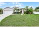 Charming single-story home with a well-manicured lawn and tropical landscaping at 145 Henue Ct, Davenport, FL 33896