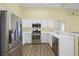 Bright kitchen featuring stainless steel appliances, white cabinets, and a convenient breakfast bar at 145 Henue Ct, Davenport, FL 33896