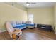 Inviting living room featuring wood flooring, vaulted ceiling, fan, comfortable seating, and natural light at 145 Henue Ct, Davenport, FL 33896
