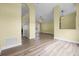 Spacious living room featuring wood flooring, neutral paint, ceiling fan, and window with natural light at 145 Henue Ct, Davenport, FL 33896