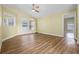 Expansive living room featuring wood flooring, a ceiling fan, a bright window, and ample natural light at 145 Henue Ct, Davenport, FL 33896