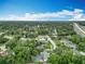An aerial view of the neighborhood with lush tree coverage and roads winding through the community at 148 Tarrytown Trl, Longwood, FL 32750