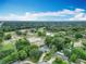 Aerial view of a private home surrounded by lush landscaping and clear blue skies at 148 Tarrytown Trl, Longwood, FL 32750