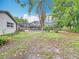 Expansive backyard with view of a screened pool and lush green foliage, ideal for outdoor enjoyment at 148 Tarrytown Trl, Longwood, FL 32750