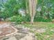 Spacious backyard featuring manicured landscaping, lush greenery, and a serene outdoor setting at 148 Tarrytown Trl, Longwood, FL 32750