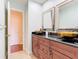 Elegant bathroom with dual vessel sinks, a granite countertop, and dark wood cabinetry at 148 Tarrytown Trl, Longwood, FL 32750