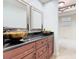 Modern bathroom with and vessel sinks and dark granite countertop, offering stylish elegance at 148 Tarrytown Trl, Longwood, FL 32750