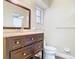 Traditional bathroom featuring a vanity with a dark wood finish, marble countertop, and a large mirror at 148 Tarrytown Trl, Longwood, FL 32750