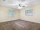 Spacious bedroom with neutral walls, carpet flooring, and two windows for natural light at 148 Tarrytown Trl, Longwood, FL 32750