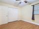 Bedroom with a ceiling fan and wood-look floors offers plenty of light with a large closet at 148 Tarrytown Trl, Longwood, FL 32750