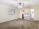 Large bedroom with a ceiling fan, built-in shelving, carpet floors, and ample closet space at 148 Tarrytown Trl, Longwood, FL 32750