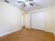 Bedroom featuring hardwood floors, fan, and a closet with double doors, offers an inviting feel at 148 Tarrytown Trl, Longwood, FL 32750