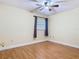 Bedroom with wood-look flooring, ceiling fan, and natural light from window at 148 Tarrytown Trl, Longwood, FL 32750