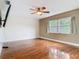 Bedroom featuring hardwood flooring, a ceiling fan, and a bright window at 148 Tarrytown Trl, Longwood, FL 32750