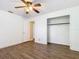 This bedroom has wood-look flooring, a ceiling fan, a closet, and a connecting door at 148 Tarrytown Trl, Longwood, FL 32750