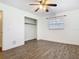 The bedroom has wood-look floors, a ceiling fan, closet, and a window for natural light at 148 Tarrytown Trl, Longwood, FL 32750