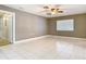 Neutral bedroom with tile flooring, a window, and a ceiling fan with light at 148 Tarrytown Trl, Longwood, FL 32750