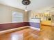 Open dining room with wainscoting and view into the kitchen at 148 Tarrytown Trl, Longwood, FL 32750