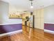 Dining area with wood flooring, open to kitchen with stainless appliances, and unique trim work at 148 Tarrytown Trl, Longwood, FL 32750