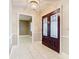Welcoming entryway featuring decorative glass double doors and white tile floors at 148 Tarrytown Trl, Longwood, FL 32750