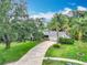 Aerial view of property with beautiful lawn, landscaping and mature trees at 148 Tarrytown Trl, Longwood, FL 32750