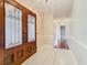 Inviting foyer featuring elegant tile flooring and double doors with decorative glass panels at 148 Tarrytown Trl, Longwood, FL 32750