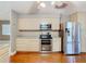 Well-equipped kitchen features stainless steel appliances and light wood cabinetry at 148 Tarrytown Trl, Longwood, FL 32750