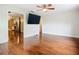 Open living room with hardwood floors and an adjacent kitchen with stainless appliances at 148 Tarrytown Trl, Longwood, FL 32750