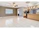 Open living area with tile flooring and a view into the kitchen with modern appliances at 148 Tarrytown Trl, Longwood, FL 32750