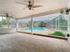 Screened in patio with two ceiling fans looking out to a sparkling in-ground pool at 148 Tarrytown Trl, Longwood, FL 32750