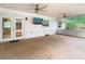 Enclosed patio featuring ceiling fans, exterior access, and views of the home's surrounding greenery at 148 Tarrytown Trl, Longwood, FL 32750