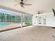 View from the enclosed patio to the inviting screened-in pool, perfect for outdoor relaxation and entertainment at 148 Tarrytown Trl, Longwood, FL 32750