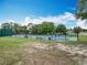 Fenced tennis and pickleball courts with benches and mature trees surrounding the area at 148 Tarrytown Trl, Longwood, FL 32750
