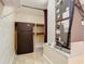This utility room includes a refrigerator, shelving, and a furnace at 148 Tarrytown Trl, Longwood, FL 32750