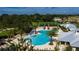 Overhead view of the community pool with waterslides, tennis courts, and meticulously landscaped grounds at 1590 Contentment Loop, Kissimmee, FL 34744